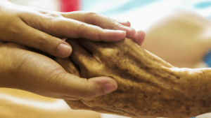 Holding elderly cardiac rehab patient's hand. Guiding elderly women through cardiac rehab. 